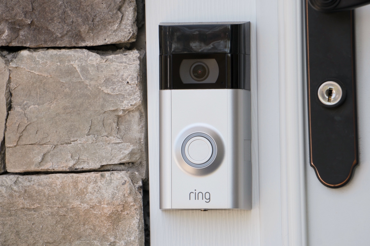 A photo of a ring doorbell next to the front door of a house